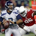 Seattle Seahawks quarterback Russell Wilson (3) throws as Arizona Cardinals nose tackle Rodney Gunter (95) pursues during the first half of a football game, Sunday, Oct. 23, 2016, in Glendale, Ariz. (AP Photo/Ross D. Franklin)