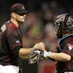 Arizona Diamondbacks relief pitcher Daniel Hudson, left, and Tuffy Gosewisch (8) celebrate after defeating the San Diego Padres in a baseball game, Saturday, Oct. 1, 2016, in Phoenix. (AP Photo/Rick Scuteri)