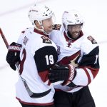 Arizona Coyotes' Shane Doan, left, and Anthony Duclair celebrate Doan's goal against the Vancouver Canucks during the second period of a preseason NHL hockey game in Vancouver, British Columbia, Monday, Oct. 3, 2016. (Darryl Dyck/The Canadian Press via AP)