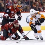 Philadelphia Flyers' Claude Giroux (28) gets the puck away from Arizona Coyotes' Brad Richardson (15) as Coyotes' Shane Doan (19) looks on during the second period of an NHL hockey game Saturday, Oct. 15, 2016, in Glendale, Ariz. (AP Photo/Ross D. Franklin)