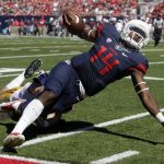 Arizona quarterback Khalil Tate (14) is taken down by Southern California defensive end Porter Gustin during the first half of an NCAA college football game, Saturday, Oct. 15, 2016, in Tucson, Ariz. (AP Photo/Rick Scuteri)