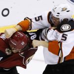 Arizona Coyotes' Jamie McGinn (88) gets in a fight with Anaheim Ducks' Korbinian Holzer (5) during the second period of a preseason NHL hockey game Saturday, Oct. 1, 2016, in Glendale, Ariz.  The Coyotes defeated the Ducks 3-2 in overtime. (AP Photo/Ross D. Franklin)