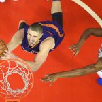 Phoenix Suns center Alex Len, left, of Ukraine, shoots as Los Angeles Clippers forward Wesley Johnson defends during the first half of an NBA basketball game, Monday, Oct. 31, 2016, in Los Angeles. (AP Photo/Mark J. Terrill)