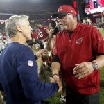 Seattle Seahawks head coach Pete Carroll, left, greets Arizona Cardinals head coach Bruce Arians after an NFL football game, Sunday, Oct. 23, 2016, in Glendale, Ariz. The game ended in overtime in a 6-6 tie. (AP Photo/Ross D. Franklin)