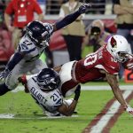 Arizona Cardinals wide receiver Brittan Golden (10) is hit by Seattle Seahawks cornerback DeAndre Elliott (21) and defensive back Neiko Thorpe (27) during the second half of a football game, Sunday, Oct. 23, 2016, in Glendale, Ariz. (AP Photo/Rick Scuteri)