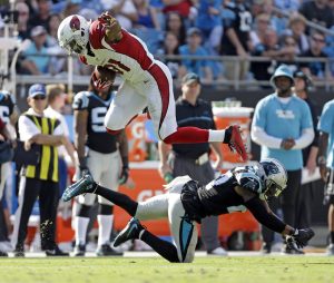 Arizona Cardinals' David Johnson (31) hurdles Carolina Panthers' Robert McClain (27) in the second half of an NFL football game in Charlotte, N.C., Sunday, Oct. 30, 2016. (AP Photo/Bob Leverone)