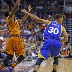 Golden State Warriors guard Stephen Curry (30) shoves Phoenix Suns guard Brandon Knight (11) for a foul during the first half of an NBA basketball game Sunday, Oct. 30, 2016, in Phoenix. (AP Photo/Ross D. Franklin)