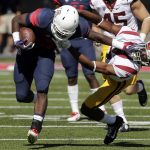 Arizona running back Nick Wilson, left, stiff-arms Southern California defensive back Marvell Tell III (7) during the first half of an NCAA college football game, Saturday, Oct. 15, 2016, in Tucson, Ariz. (AP Photo/Rick Scuteri)