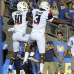 Arizona wide receivers Samajie Grant (10) and Cam Denson (3) celebrate Grant's catch for a touchdown against UCLA during the first half of an NCAA college football game Saturday, Oct. 1, 2016, in Pasadena, Calif. (AP Photo/Reed Saxon)