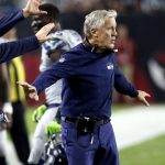 Seattle Seahawks head coach Pete Carroll holds back his bench while waiting for a call during the first half of a football game against the Arizona Cardinals, Sunday, Oct. 23, 2016, in Glendale, Ariz. (AP Photo/Ross D. Franklin)