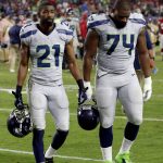 Seattle Seahawks cornerback DeAndre Elliott (21) and tight end George Fant (74) leave the field after an NFL football game against the Arizona Cardinals, Sunday, Oct. 23, 2016, in Glendale, Ariz. The game ended in overtime in a 6-6 tie. (AP Photo/Ross D. Franklin)