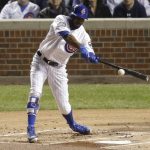 Chicago Cubs' Dexter Fowler hits a double against the Cleveland Indians during the first inning of Game 4 of the Major League Baseball World Series Saturday, Oct. 29, 2016, in Chicago. (AP Photo/Charles Rex Arbogast)