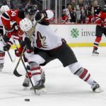 New Jersey Devils center Adam Henrique (14) gets tangled up with Arizona Coyotes center Ryan White (25) during the first period of an NHL hockey game, Tuesday, Oct. 25, 2016, in Newark, N.J. (AP Photo/Julie Jacobson)