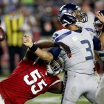 Arizona Cardinals outside linebacker Chandler Jones (55) forces Seattle Seahawks quarterback Russell Wilson (3) to fumble during the second half of a football game, Sunday, Oct. 23, 2016, in Glendale, Ariz. The Seahawks recovered the ball and had to punt. (AP Photo/Ross D. Franklin)