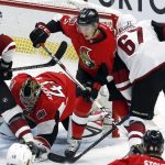 Ottawa Senators' Thomas Chabot (72) defends the net against Arizona Coyotes' Lawson Crouse (67) as Senators goaltender Craig Anderson (41) grabs the puck during the first period of an NHL hockey game Tuesday, Oct. 18, 2016, in Ottawa, Ontario. (Fred Chartrand/The Canadian Press via AP)