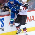 Arizona Coyotes' Luke Schenn, right, checks Vancouver Canucks' Troy Stecher during the third period of a preseason NHL hockey game in Vancouver, British Columbia, Monday, Oct. 3, 2016. (Darryl Dyck/The Canadian Press via AP)