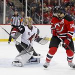 New Jersey Devils center Adam Henrique (14) knocks the puck past Arizona Coyotes goalie Justin Peters (40) for a goal during the second period of an NHL hockey game, Tuesday, Oct. 25, 2016, in Newark, N.J. (AP Photo/Julie Jacobson)
