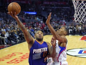 Phoenix Suns forward P.J. Tucker, left, shoots as Los Angeles Clippers forward Wesley Johnson defends during the second half of an NBA basketball game, Monday, Oct. 31, 2016, in Los Angeles. The Clippers won 116-98. (AP Photo/Mark J. Terrill)