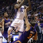 Sacramento Kings center DeMarcus Cousins (15) fouls Phoenix Suns forward Jared Dudley (3) during the first half of an NBA basketball game, Wednesday, Oct. 26, 2016, in Phoenix. (AP Photo/Matt York)