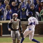 Chicago Cubs' Dexter Fowler, right, scores past Cleveland Indians catcher Roberto Perez on a single by Anthony Rizzo during the first inning of Game 4 of the Major League Baseball World Series Saturday, Oct. 29, 2016, in Chicago. (AP Photo/Charlie Riedel)