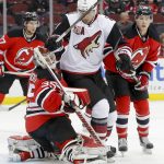 Arizona Coyotes center Martin Hanzal (11) collides with New Jersey Devils goalie Cory Schneider (35) during the first period of an NHL hockey game, Tuesday, Oct. 25, 2016, in Newark, N.J. (AP Photo/Julie Jacobson)
