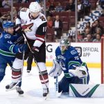 Vancouver Canucks' goalie Jacob Markstrom, right, of Sweden, makes a save as Troy Stecher, left, checks Arizona Coyotes' Martin Hanzal, of the Czech Republic, during the first period of a preseason NHL hockey game in Vancouver, British Columbia, Monday Oct. 3, 2016. (Darryl Dyck/The Canadian Press via AP)