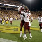 Washington State running back Jamal Morrow (25) celebrates his touchdown catch with teammate Isaiah Johnson-Mack during the second half of an NCAA college football game against Arizona State, Saturday, Oct. 22, 2016, in Tempe, Ariz. (AP Photo/Matt York)