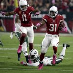 Arizona Cardinals running back David Johnson (31) runs for a touchdown against the New York Jets as teammate Larry Fitzgerald (11) follows during the first half of an NFL football game, Monday, Oct. 17, 2016, in Glendale, Ariz. (AP Photo/Rick Scuteri)