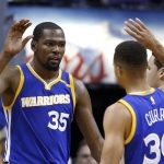 Golden State Warriors forward Kevin Durant (35) celebrates a score against the Phoenix Suns with guard Stephen Curry (30) during the second half of an NBA basketball game Sunday, Oct. 30, 2016, in Phoenix. The Warriors defeated the Suns 106-100. (AP Photo/Ross D. Franklin)