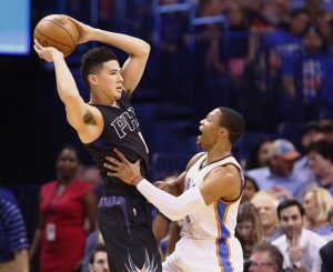 Phoenix Suns guard Devin Booker, left, looks to pass as Oklahoma City Thunder guard Russell Westbrook defends during the first quarter of an NBA basketball game in Oklahoma City, Friday, Oct. 28, 2016. (AP Photo/Alonzo Adams)