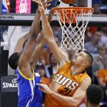 Phoenix Suns center Alex Len (21) blocks the shot of Golden State Warriors forward Kevon Looney, left, during the second half of an NBA basketball game Sunday, Oct. 30, 2016, in Phoenix. The Warriors defeated the Suns 106-100. (AP Photo/Ross D. Franklin)