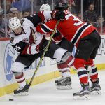 Arizona Coyotes center Ryan White (25) battles New Jersey Devils center Pavel Zacha (37) for the puck during the first period of an NHL hockey game, Tuesday, Oct. 25, 2016, in Newark, N.J. (AP Photo/Julie Jacobson)