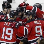 New Jersey Devils center Travis Zajac (19) celebrates with teammates after scoring a goal against the Arizona Coyotes during the third period of an NHL hockey game, Tuesday, Oct. 25, 2016, in Newark, N.J. The Devils won 5-3. (AP Photo/Julie Jacobson)