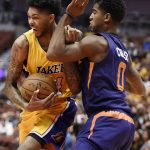 Los Angeles Lakers forward Brandon Ingram, left, drives the ball while being fouled by Phoenix Suns forward Marquese Chriss, right, during the first half of an NBA basketball game in Anaheim, Calif., Friday, Oct. 21, 2016. (AP Photo/Kelvin Kuo)