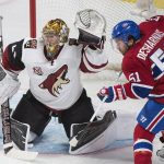 Arizona Coyotes goaltender Justin Peters attempts a save as Montreal Canadiens' David Desharnais looks for a rebound during the second period of an NHL hockey game, Thursday, Oct. 20, 2016 in Montreal. (Graham Hughes/The Canadian Press via AP)