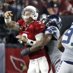 Arizona Cardinals quarterback Carson Palmer (3) his hit as he throws by Seattle Seahawks defensive tackle Ahtyba Rubin during the second half of a football game, Sunday, Oct. 23, 2016, in Glendale, Ariz. (AP Photo/Ross D. Franklin)