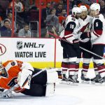 Philadelphia Flyers goalie Steve Mason looks back for the puck as the Arizona Coyotes' from the left, Anthony Duclair, Jamie McGinn and Connor Murphy celebrate McGinn's goal during the first period of an NHL hockey game, Thursday, Oct. 27, 2016, in Philadelphia. (AP Photo/Tom Mihalek)