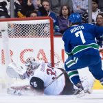 Arizona Coyotes' goalie Louis Domingue, left, stops Vancouver Canucks' Tuomo Ruutu, of Finland, during the first period of a preseason NHL hockey game in Vancouver, British Columbia, Monday Oct. 3, 2016. (Darryl Dyck/The Canadian Press via AP)