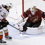 Arizona Coyotes goalie Mike Smith, right, makes a save on a deflection from Anaheim Ducks' Michael Sgarbossa (48) during overtime of a preseason NHL hockey game Saturday, Oct. 1, 2016, in Glendale, Ariz.  The Coyotes defeated the Ducks 3-2 in overtime. (AP Photo/Ross D. Franklin)