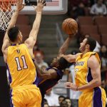 Phoenix Suns guard Brandon Knight, center, attempts a shot while being fouled by Los Angeles Lakers forward Larry Nance Jr., right, as center Yi Jianlian defends during the first half of an NBA preseason basketball game in Anaheim, Calif., Friday, Oct. 21, 2016. (AP Photo/Kelvin Kuo)