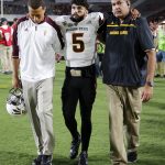 Arizona State quarterback Manny Wilkins (5), center, is helped off the field after being injured during the first half of an NCAA college football game against Southern California Saturday, Oct. 1, 2016, in Los Angeles. (AP Photo/Ryan Kang)