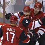 Arizona Coyotes' Martin Hanzal (11) celebrates his goal against the Philadelphia Flyers with Radim Vrbata (17) and Jakob Chychrun (6) during the first period of an NHL hockey game Saturday, Oct. 15, 2016, in Glendale, Ariz. (AP Photo/Ross D. Franklin)