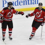 New Jersey Devils center Adam Henrique (14) congratulates New Jersey Devils center Travis Zajac (19) after Zajac scored an open-net goal against the Arizona Coyotes during the third period of an NHL hockey game, Tuesday, Oct. 25, 2016, in Newark, N.J. The Devils won 5-3. (AP Photo/Julie Jacobson)