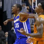 Golden State Warriors forward Kevin Durant (35) celebrates a score as Phoenix Suns guard Eric Bledsoe, right, gestures in frustration during the second half of an NBA basketball game Sunday, Oct. 30, 2016, in Phoenix. The Warriors defeated the Suns 106-100. (AP Photo/Ross D. Franklin)