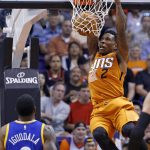 Phoenix Suns guard Eric Bledsoe (2) dunks as Golden State Warriors forward Andre Iguodala (9) watches during the first half of an NBA basketball game Sunday, Oct. 30, 2016, in Phoenix. (AP Photo/Ross D. Franklin)