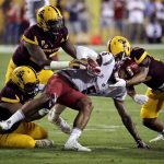Washington State wide receiver Isaiah Johnson-Mack (5) is hit by Arizona State defensive lineman Edmond Boateng, left rear, and linebacker Salamo Fiso, left front, during the first half of an NCAA college football game, Saturday, Oct. 22, 2016, in Tempe, Ariz. (AP Photo/Matt York)