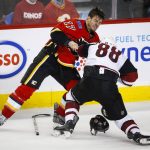 Arizona Coyotes' Jamie McGinn, right, fights with Calgary Flames' Lance Bouma during the second period of an NHL preseason hockey game in Calgary, Alberta, Wednesday, Oct. 5, 2016. (Jeff McIntosh/The Canadian Press via AP)