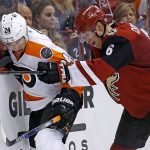 Arizona Coyotes' Jakob Chychrun (6) checks Philadelphia Flyers' Matt Read (24) into the boards during the second period of an NHL hockey game, Saturday, Oct. 15, 2016, in Glendale, Ariz. (AP Photo/Ross D. Franklin)