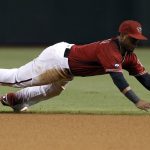 Arizona Diamondbacks second baseman Jean Segura makes a diving catch of a sharply hit ground ball by San Diego Padres' Austin Hedges during the fifth inning of a baseball game, Sunday, Oct. 2, 2016, in Phoenix. (AP Photo/Ralph Freso)