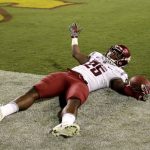 Washington State running back Jamal Morrow (25) falls in the end zone after a touchdown catch against Arizona State during the second half of an NCAA college football game, Saturday, Oct. 22, 2016, in Tempe, Ariz. (AP Photo/Matt York)